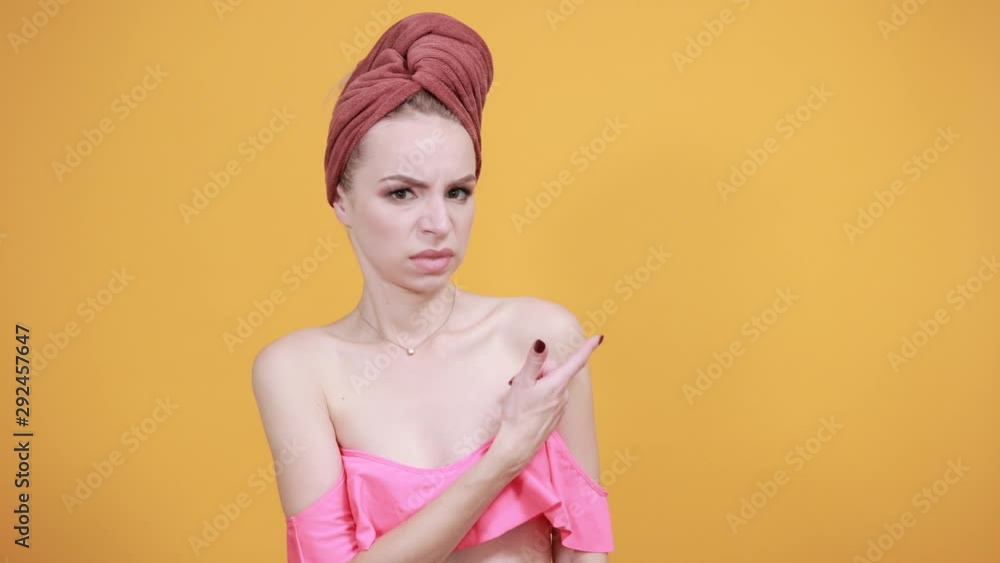 young girl with towel on her head over isolated orange background shows emotions young girl with towel on her head over isolated orange background shows emotions