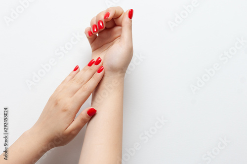 Canvas Print Female red nails on white background.