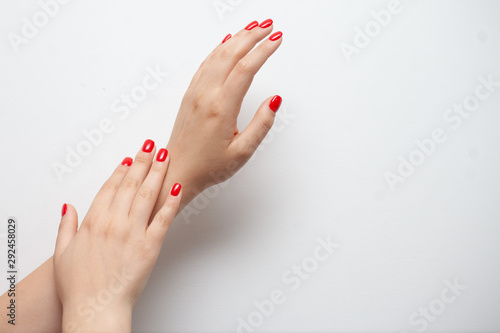 Fototapeta Female red nails on white background.