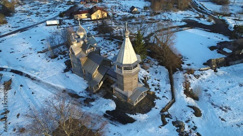 The ancient wooden church of Dmitry Solunsky, April evening (shooting from a quadrocopter). Village Shcheljeki. Leningrad region, Russia   photo