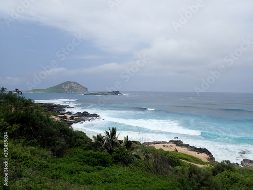 Waves crash on Makapuu Beach with the Koolau Range Mountains above looking towards Waimanalo Bay