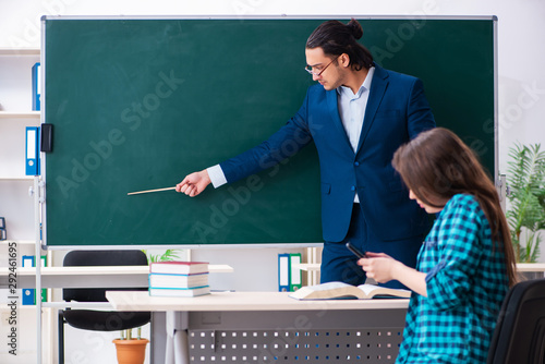 Young handsome teacher and female student in the classroom © Elnur