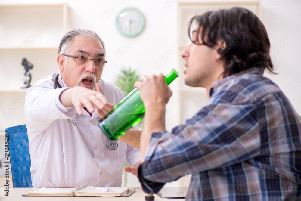 Young male alcoholic visiting old doctor Young male alcoholic visiting old doctor