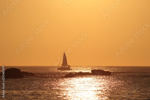 a sailboat on the horizon in a sunset at sea © Marcos