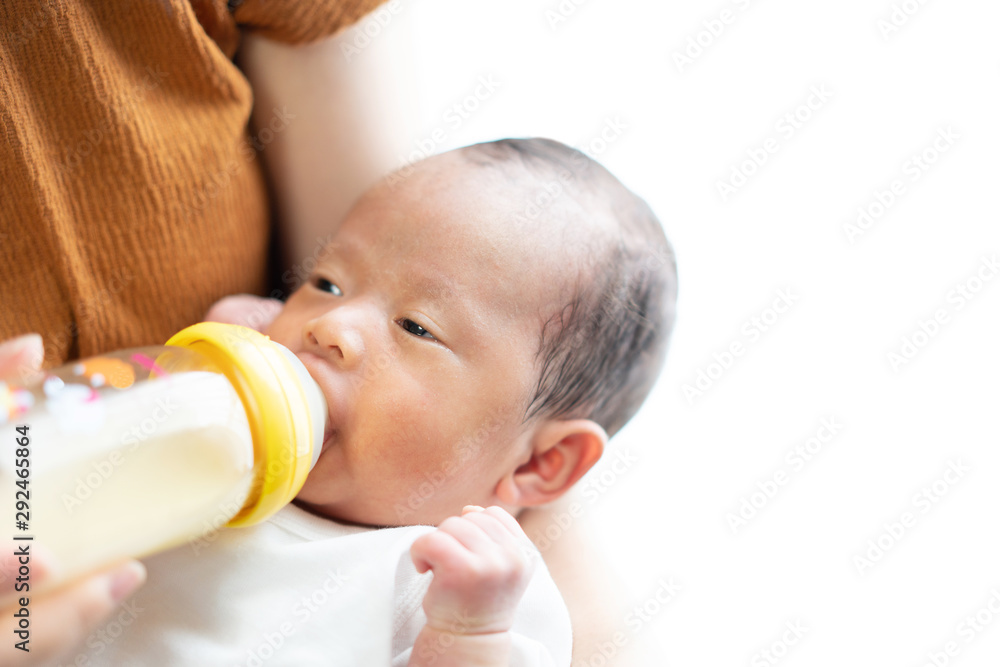Mother feeding her baby with baby bottle Mother feeding her baby with baby bottle
