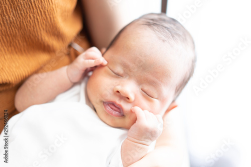 Baby held by his mother