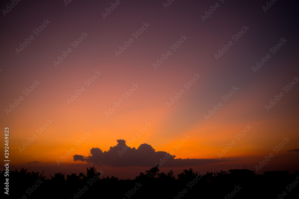 Fiery sunset landscape with darkness foreground in siem reap city in Cambodia during rainy season Fiery sunset landscape with darkness foreground in siem reap city in Cambodia during rainy season
