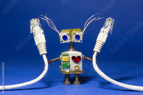 Robot toy with computer internet wires in his hand. photo