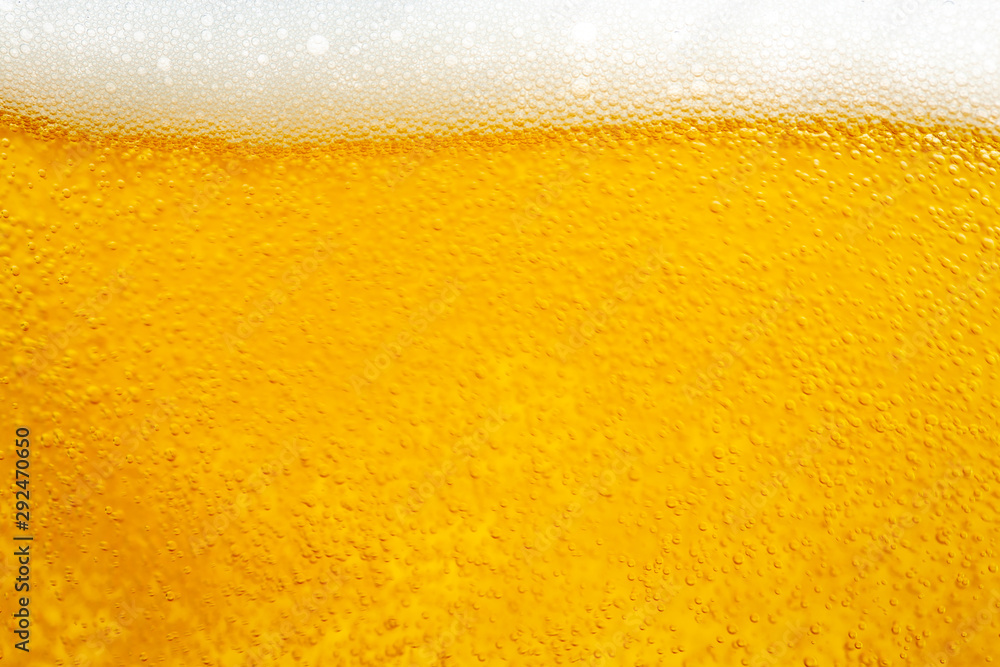 Pouring beer with bubble froth in glass for background and design. Pouring beer with bubble froth in glass for background and design.