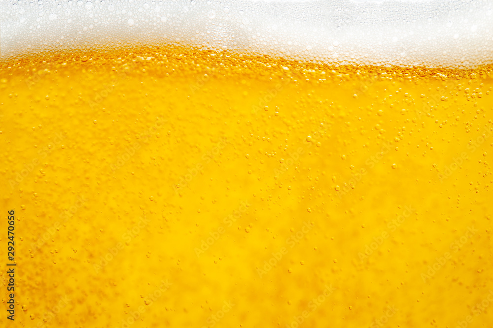 Pouring beer with bubble froth in glass for background and design. Pouring beer with bubble froth in glass for background and design.