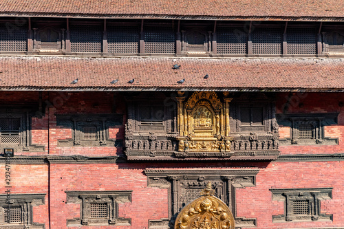 Nepalese traditional style windows, doors and wood carvings on the walls of an ancient palace.