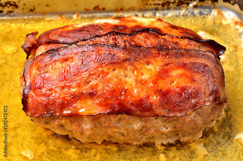 Tasty baked pork meatloaf in pan. Close-up.