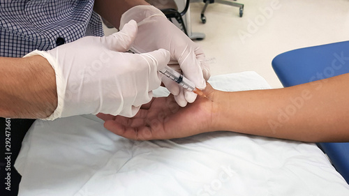 Doctor giving the anti-inflammatory drug injection to patient ‘s hand for treatment carpal tunnel syndrome(CTS) or median nerve compressive neuropathy disease. Medical and Physical therapy concept