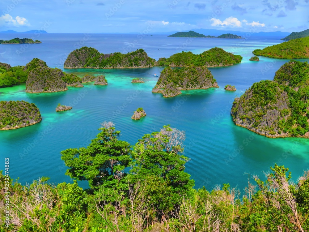Green islands in the azure sea. Ocean and small tropical islands. Paradise exotic seascape scenery.