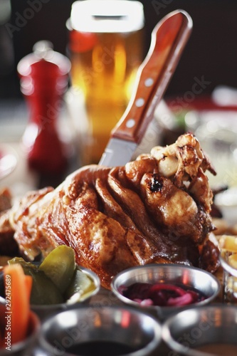 Obraz na płótnie Pork knuckle with carrot, cucumber, sauce and beer on the background. w salonie