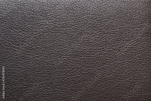 Dark brown artificial leather texture. Closeup. Leatherette background