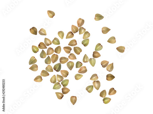 Large group of green buckwheat seeds spread out and isolated on white background