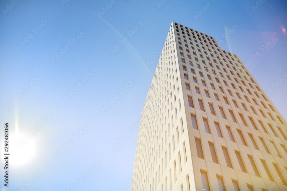 Modern office building detail. Perspective view of geometric angular concrete windows on the facade of a modernist brutalist style building surface with sunlight. Modern office building detail. Perspective view of geometric angular concrete windows on the facade of a modernist brutalist style building surface with sunlight.