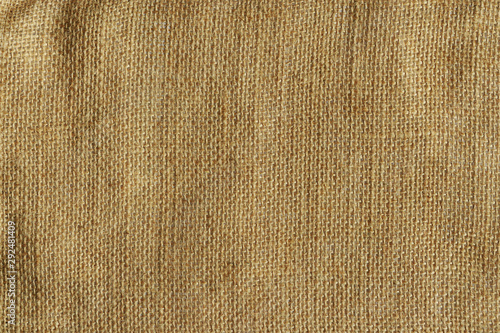 Detailed natural burlap background. Grunge khaki brown rough sackcloth fabric texture photo