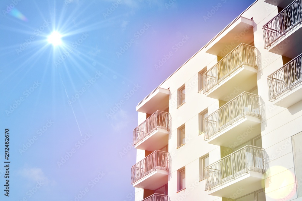 Modern apartment buildings on a sunny day with a blue sky. Facade of a modern apartment building.Glass surface with sunlight.