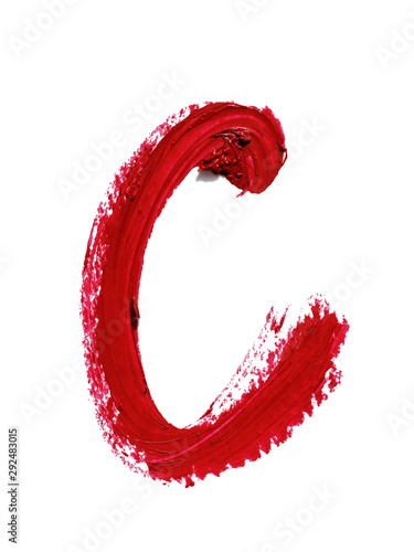 Large letter C of English or Russian alphabet handwritten by dark red color melted lipstick. Roman or Cyrillic  character isolated on white background. Closeup