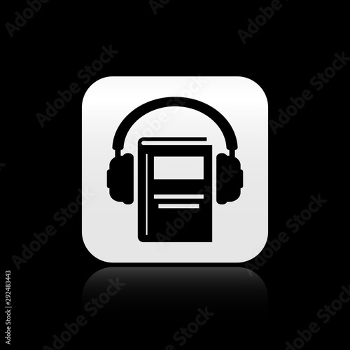 Black Audio book icon isolated on black background. Book with headphones. Audio guide sign. Online learning concept. Silver square button. Vector Illustration
