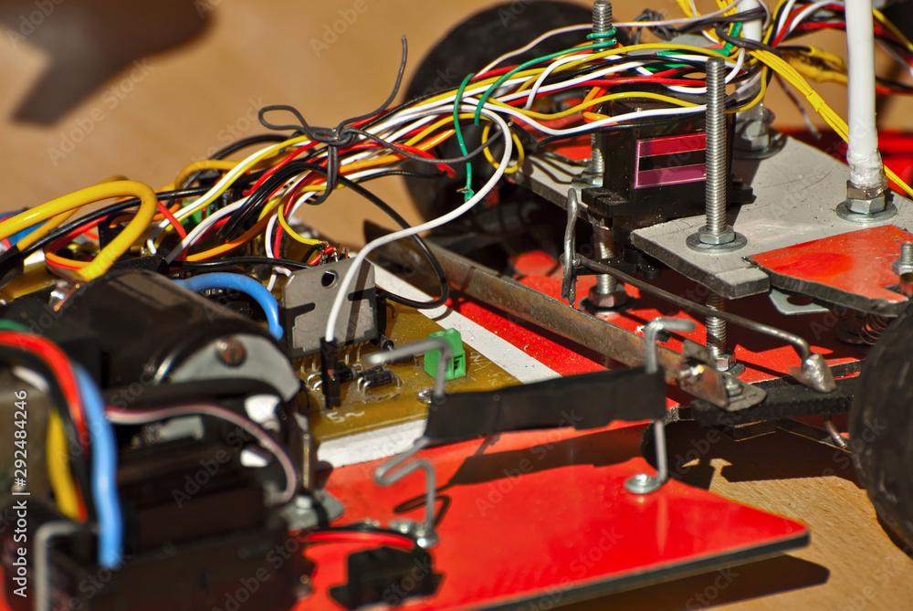 Electronics and robotics of handmade. Microcircuits and colored wires close up. Electronic devices and mechanisms are presented at the scientific exhibition. Electronics and robotics of handmade. Microcircuits and colored wires close up. Electronic devices and mechanisms are presented at the scientific exhibition.