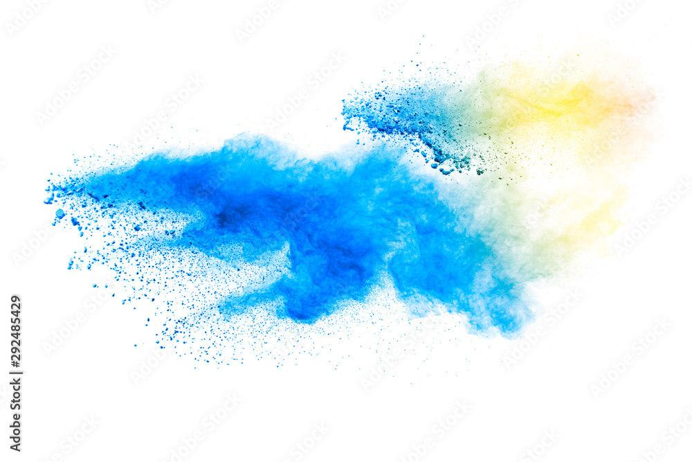 Abstract yellow blue dust explosion on white background. Freeze motion of yellow blue powder splash.