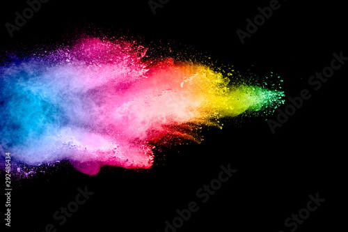 Colorful background of pastel powder explosion.Multi colored dust splash on black background.Painted Holi.