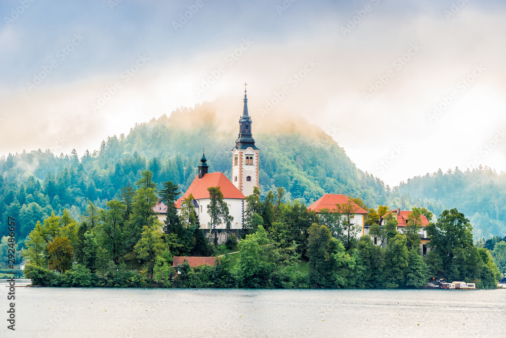 View at the Church of Assumption of St.Mary in morning haze at the Island of Bled Lake in Slovenia