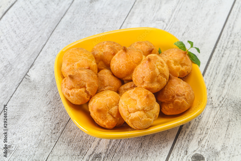 Sweet tasty profiteroles heap in the bowl Sweet tasty profiteroles heap in the bowl