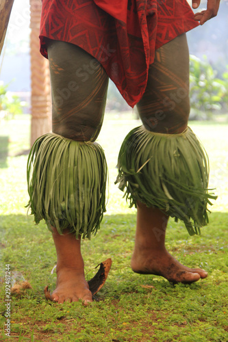 A samoan man using his feet to putting out a fire. In tradition, Samoan people using coconut fibre to light up the fire.