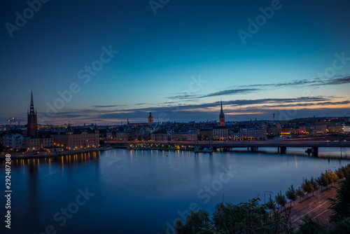 A colorful sunrise over Stockholm with the lights reflecting on the calm water of the sea - 11