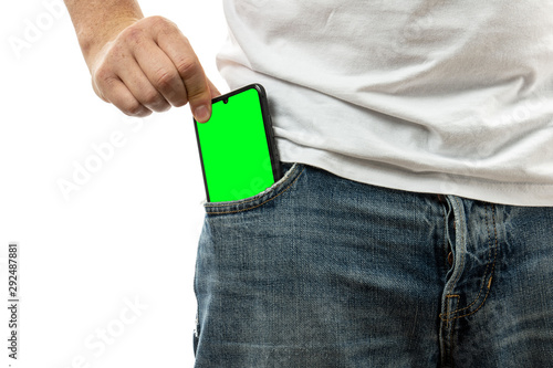 A man pulls a smartphone out of the front pocket of his jeans