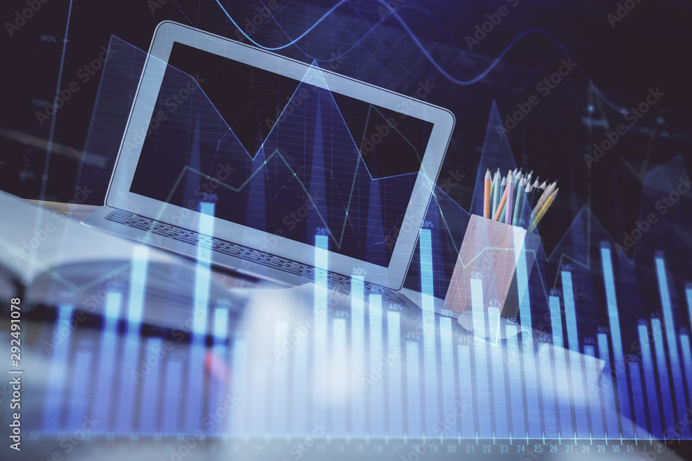 Forex Chart hologram on table with computer background. Double exposure. Concept of financial markets. Forex Chart hologram on table with computer background. Double exposure. Concept of financial markets.