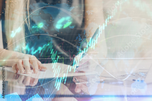 A woman hands writing information about stock market in notepad. Forex chart holograms in front. Concept of research. Double exposure