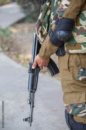 Warrior holding a automatic machine gun. New Delhi, India. Closeup