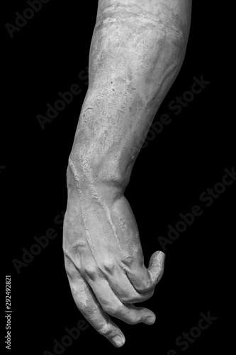 Stone statue detail of human hand isolated on black background by clipping path