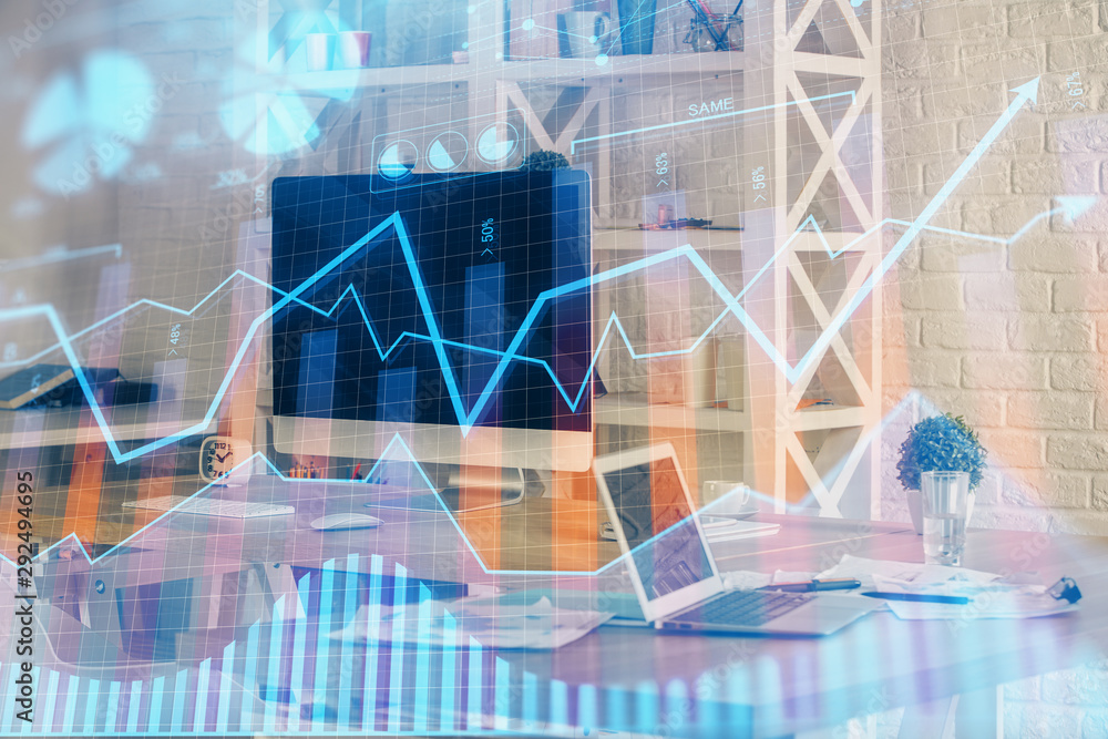 Forex Chart hologram on table with computer background. Double exposure. Concept of financial markets. Forex Chart hologram on table with computer background. Double exposure. Concept of financial markets.