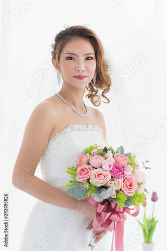 Bride is stands in beautiful white wedding dress..