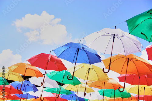 many colorful sunny umbrellas decorate the street