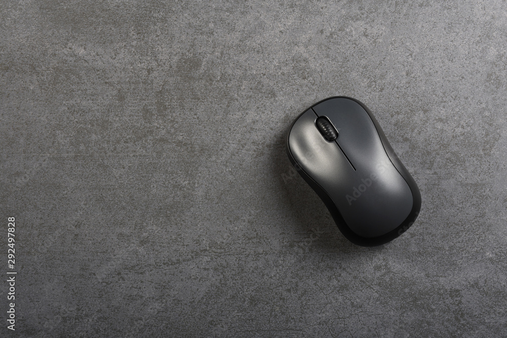 Computer mouse on the gray stone texture with copy space Computer mouse on the gray stone texture with copy space