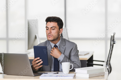 Businessman uses tablet computer be a mirror..