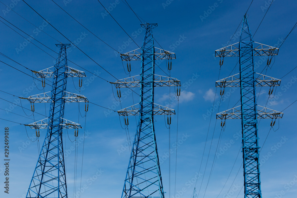 Electrical power lines on a blue sky background.