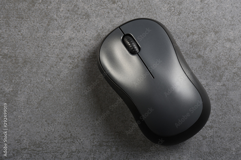 Computer mouse on the gray stone texture with copy space Computer mouse on the gray stone texture with copy space