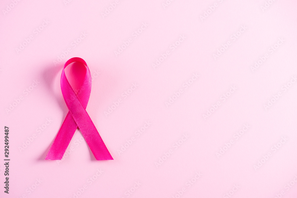 Pink ribbon on pink pastel paper background for supporting breast cancer awareness month campaign. Pink ribbon on pink pastel paper background for supporting breast cancer awareness month campaign.