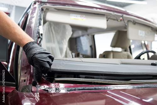 Automobile special workers glazier replacing windscreen windshield of car