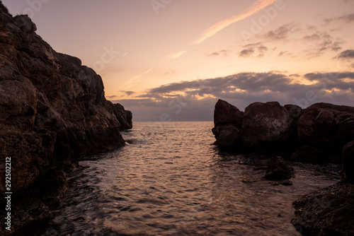 Sunrise between rocks and the Oropesa Sea