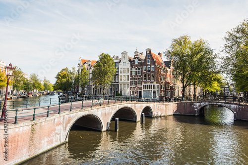 Charming street and canals in Amsterdam old town, Netherlands. Popular travel destination and tourist attraction