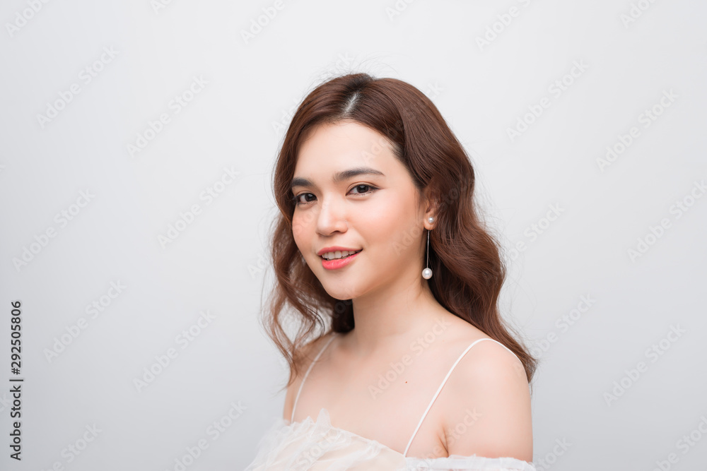 Beautiful smiling young asian woman with clean, fresh, glow, and perfect skin in white dress Beautiful smiling young asian woman with clean, fresh, glow, and perfect skin in white dress